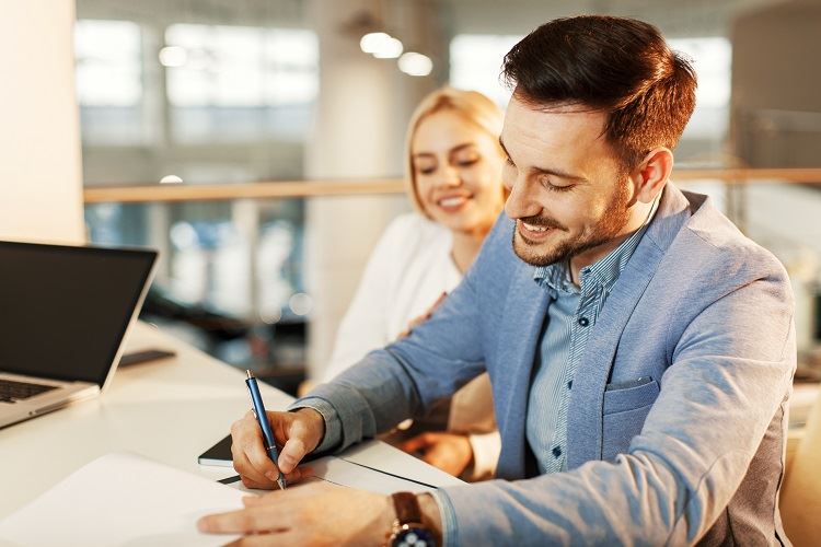 Young business couple signing a Prenup